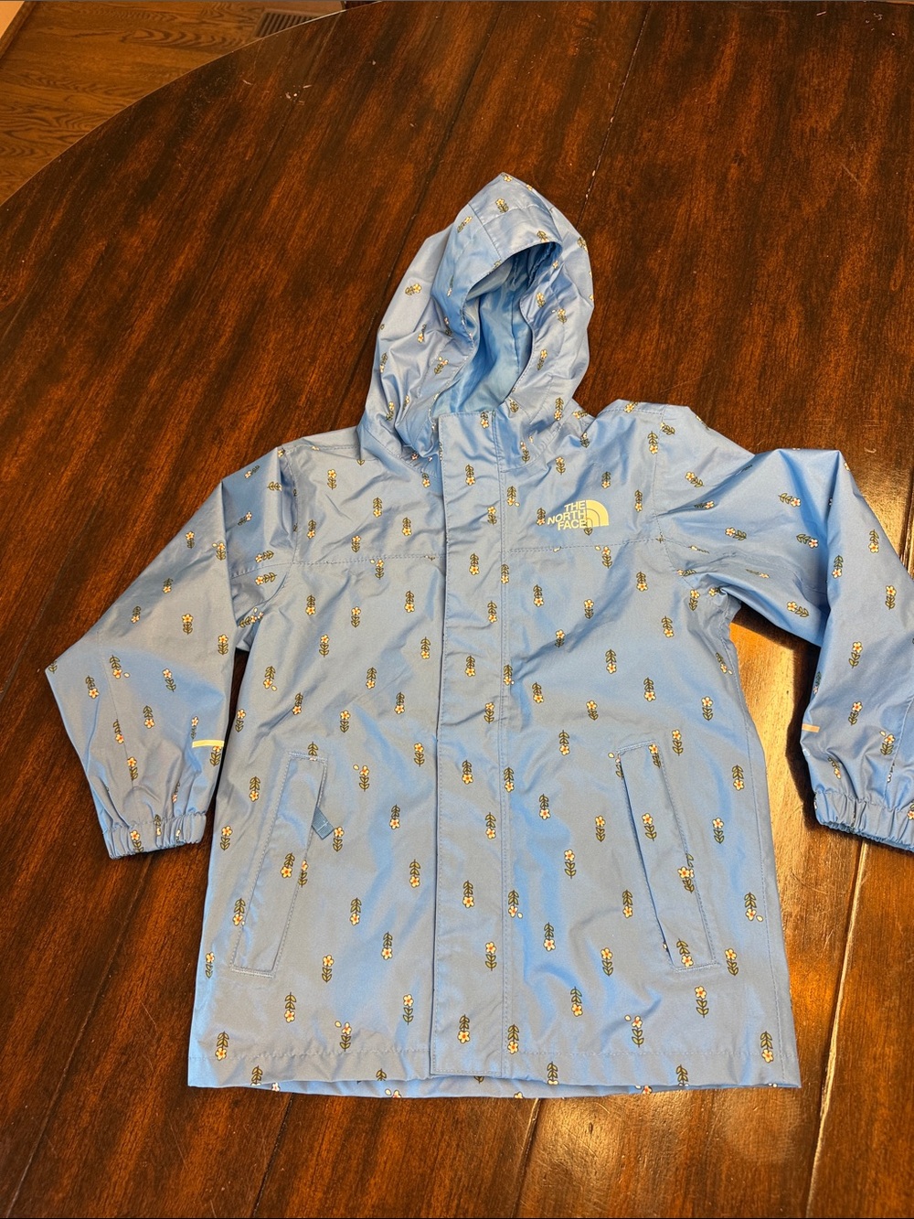 The North Face Light Blue Hooded Kids' Raincoat with Pineapple Motif